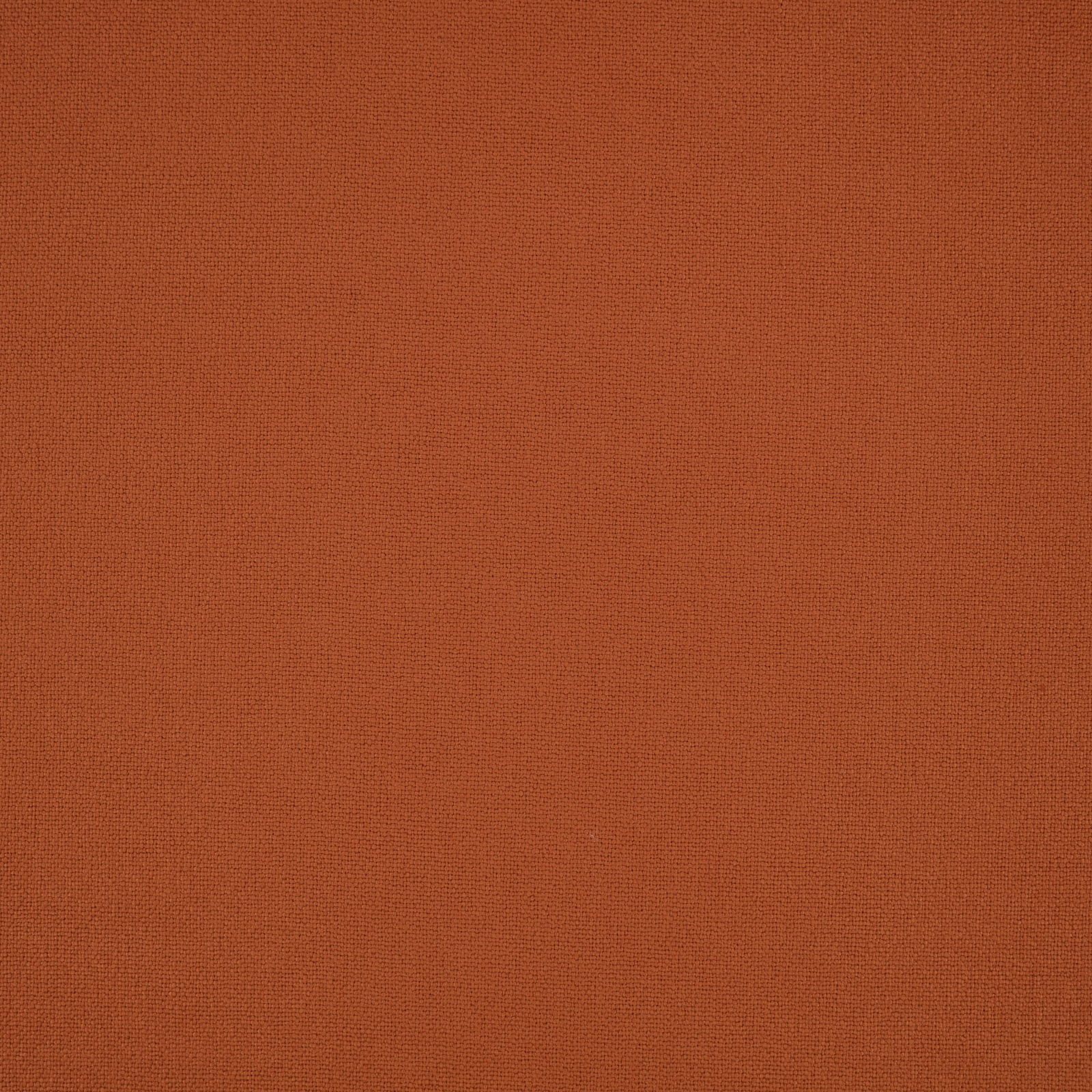 Close-up of Elio Cajun’s finely woven rust-orange plain fabric surface