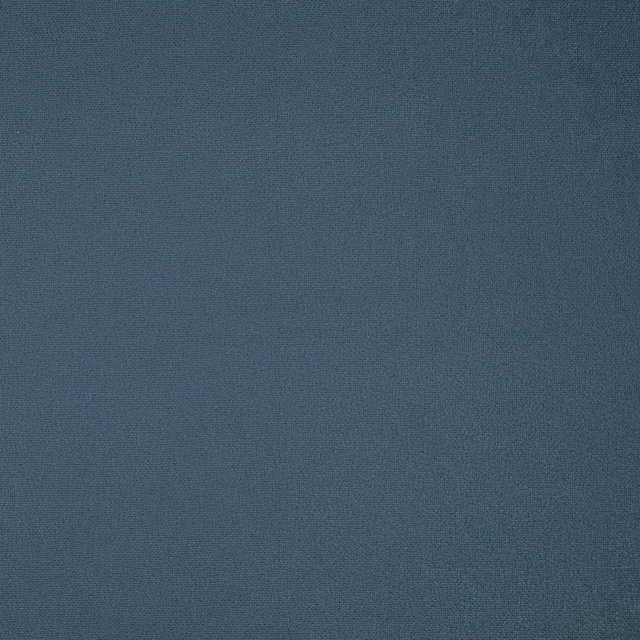 Close-up of finely woven matte indigo-blue Elio fabric with subtle tonal depth