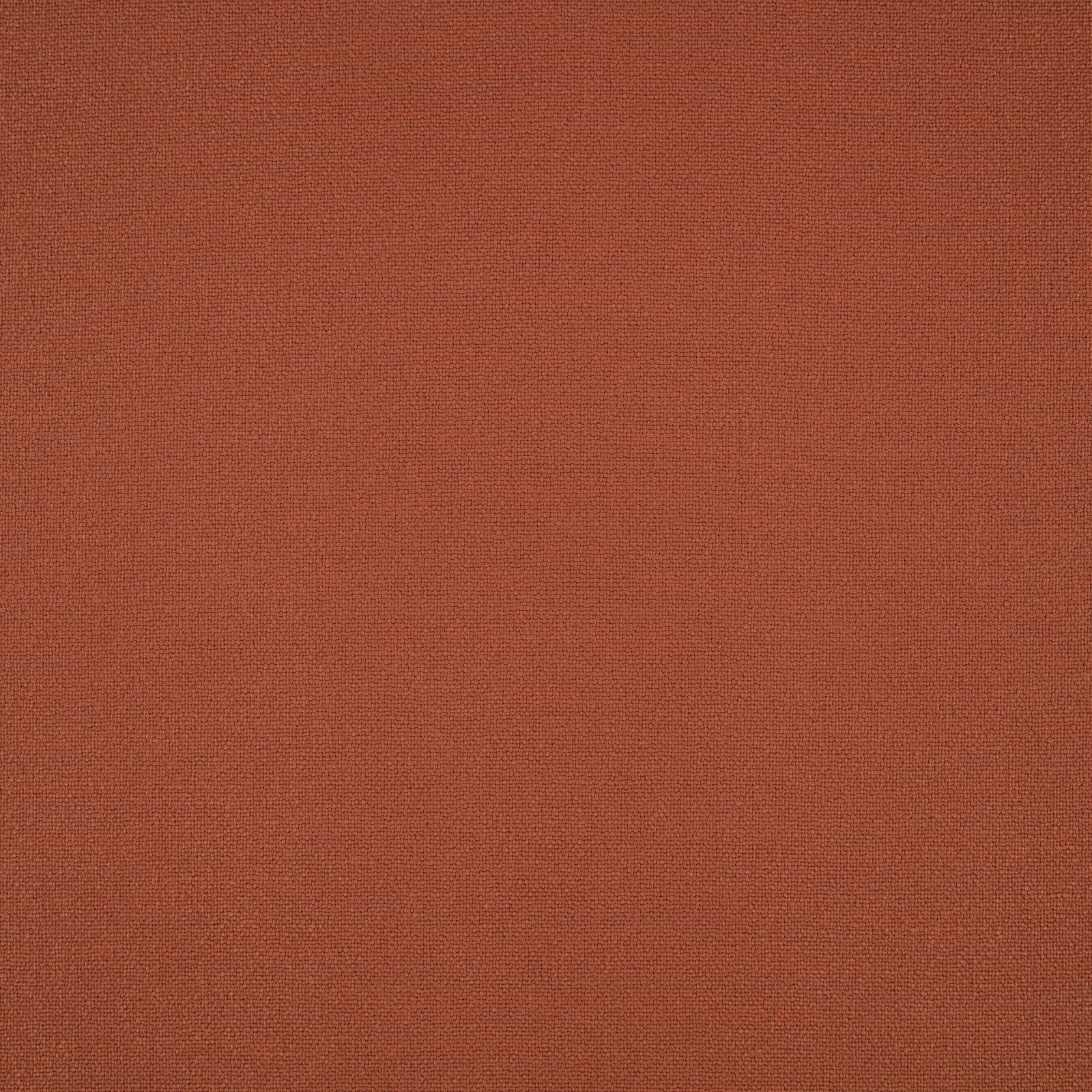 Close-up of warm terracotta fabric with a fine, even woven texture
