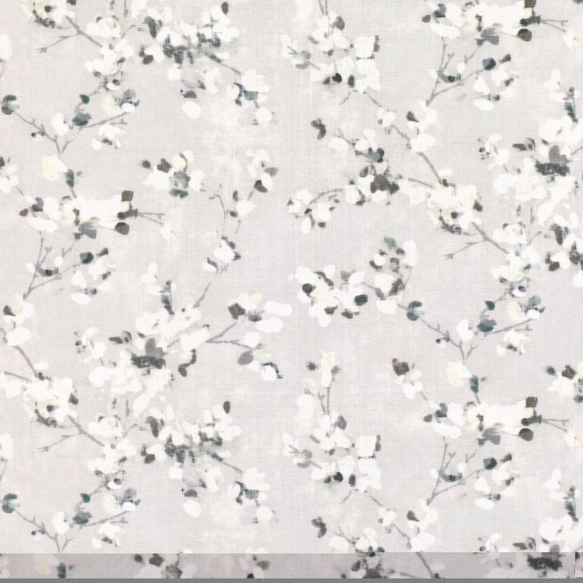 Pale quartz-grey fabric with scattered white blossoms and charcoal-grey leafy sprigs