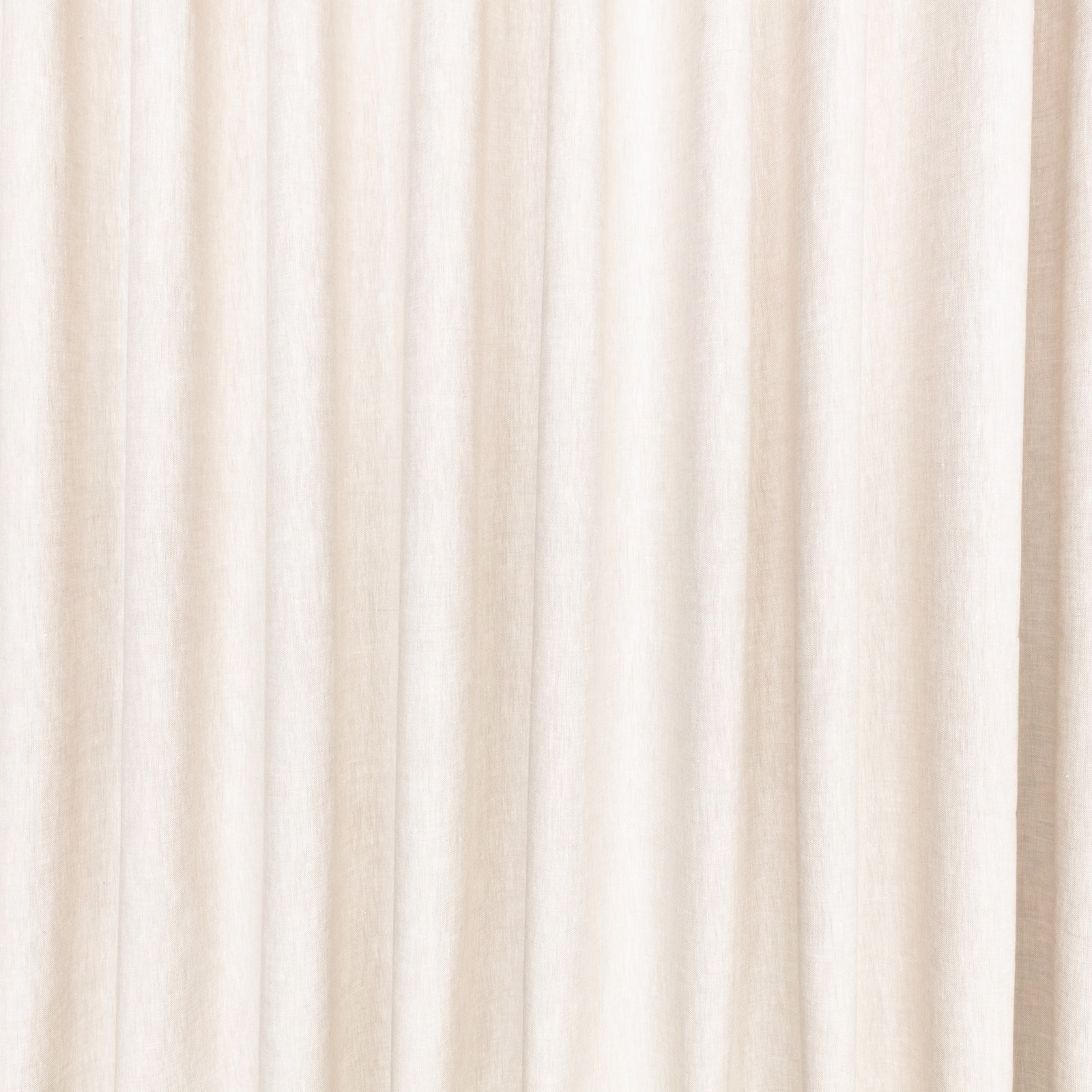 Pale sandstone beige fabric with softly irregular vertical striations in hanging folds