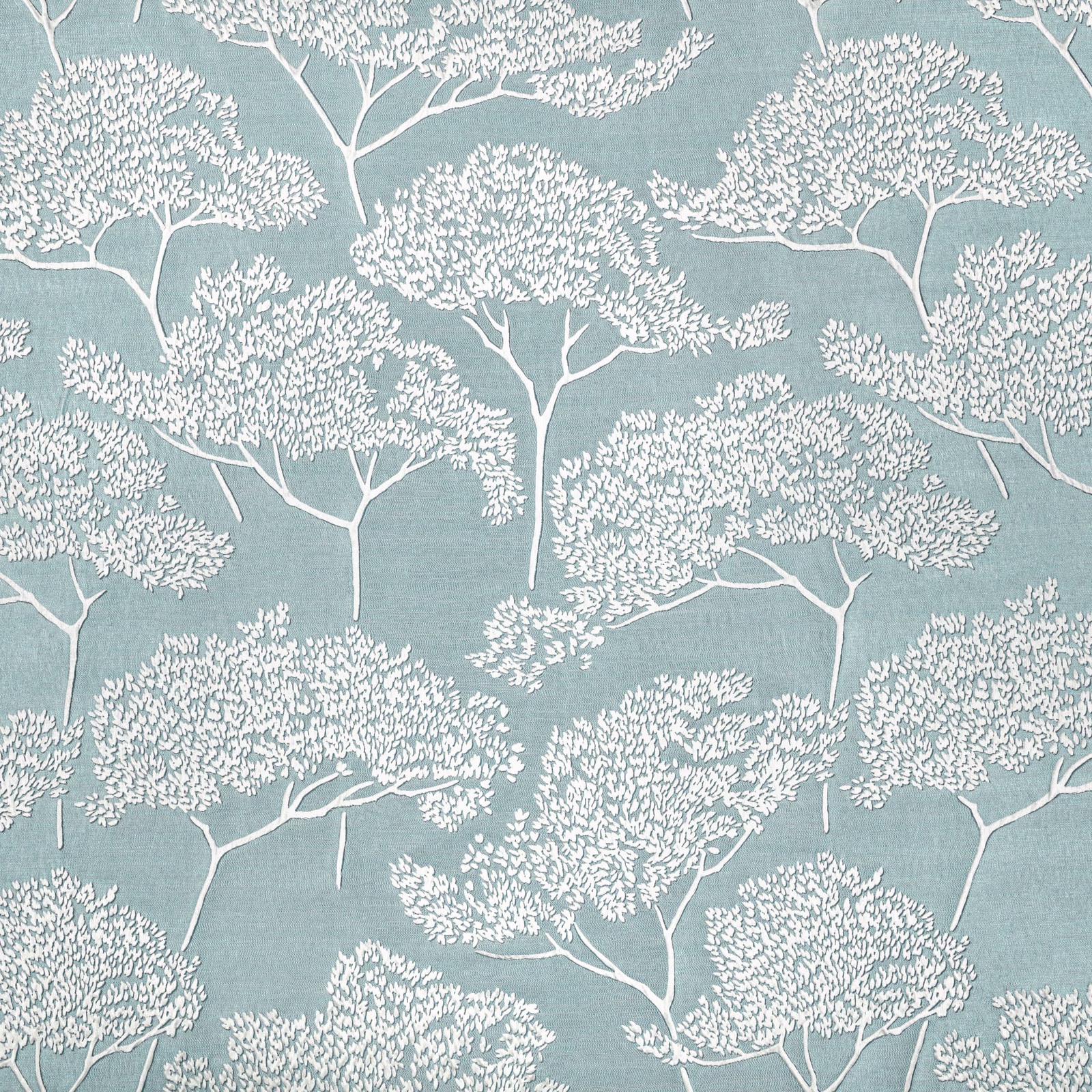 Muted blue-teal fabric with delicate white branching trees and fine woven texture