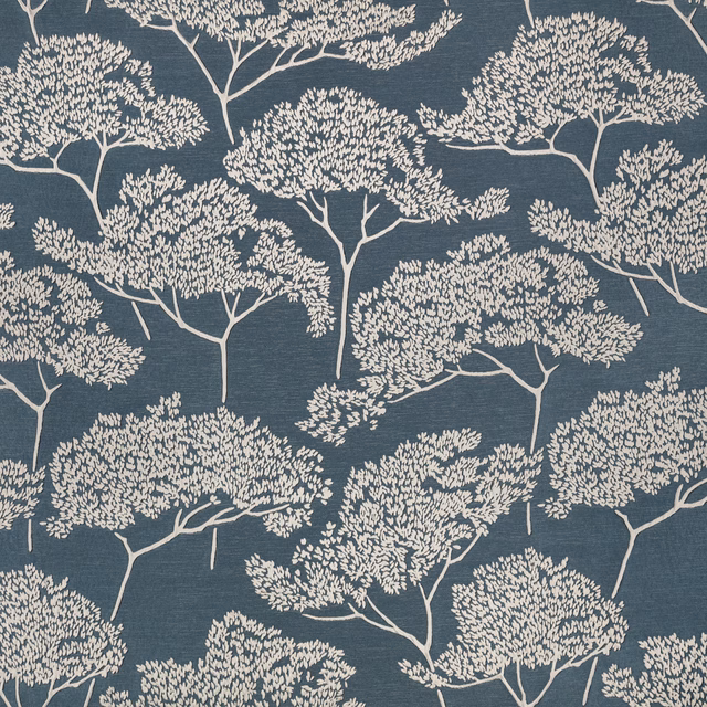 Cream branching tree motifs across a cool gunmetal blue-grey woven textile