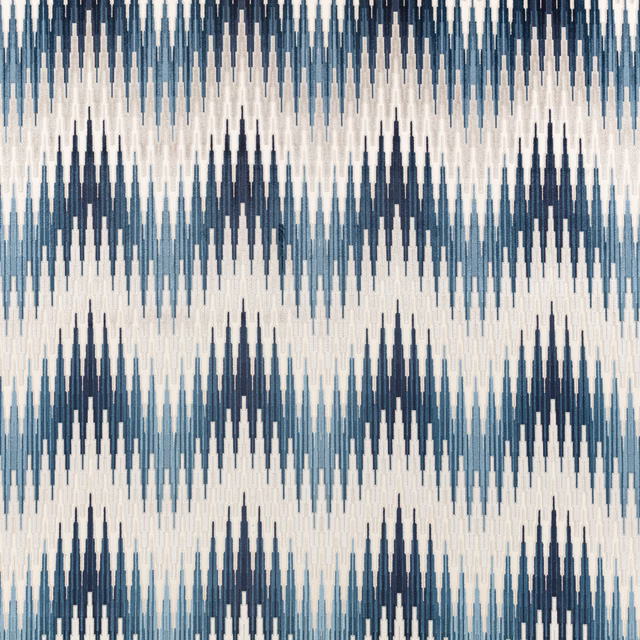 Indigo and pale blue elongated ikat motifs woven across an ivory fabric ground
