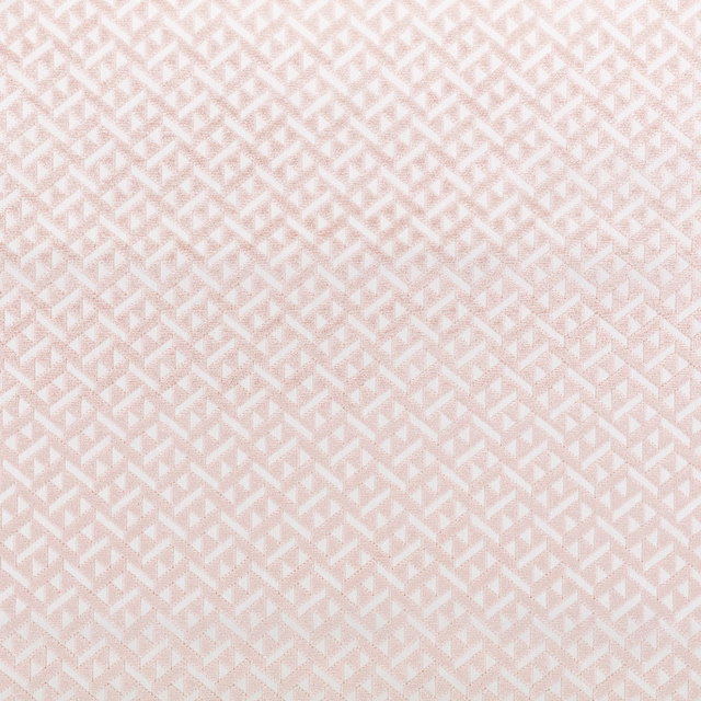 Soft blush pink fabric with tiny ivory stepped geometric motifs and fine woven texture