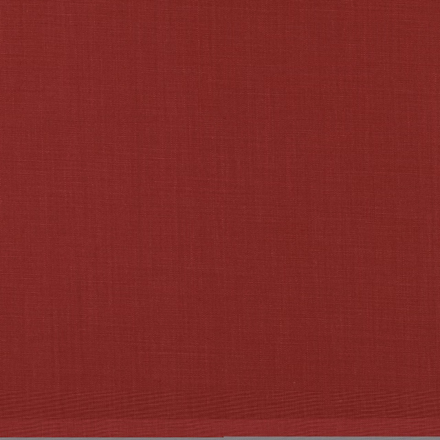Close-up of plain cranberry-red woven fabric with subtle horizontal slub texture