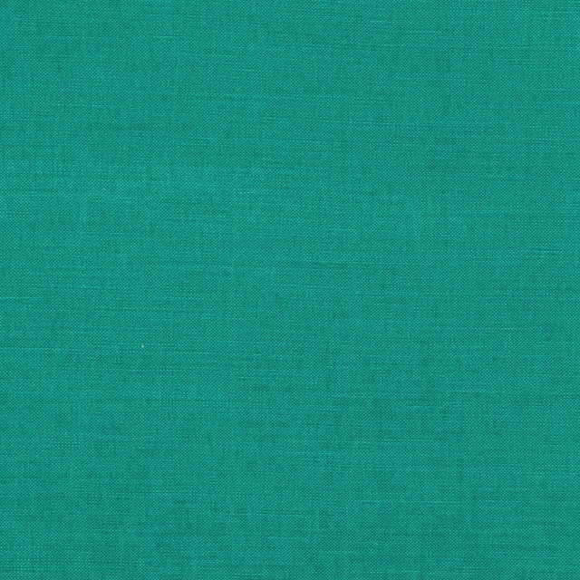 Close-up of saturated turquoise-teal fabric with a fine, even woven texture
