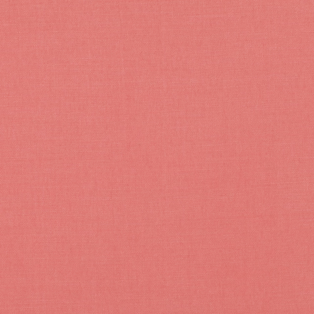 Close-up of coral-pink Guava fabric showing a fine, even woven texture