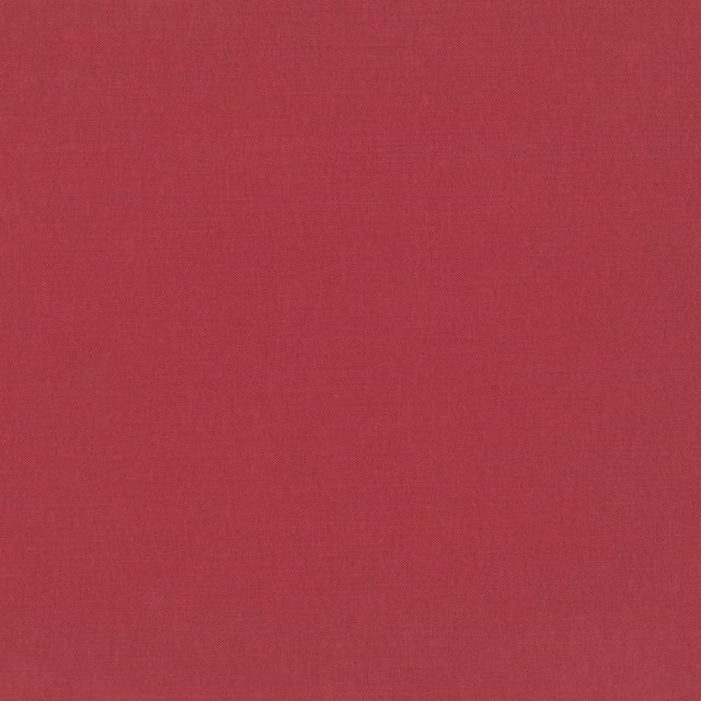 Close-up of warm muted red Linara fabric with a fine woven texture