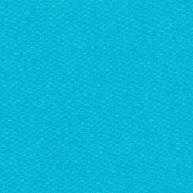 Close-up of tightly woven saturated turquoise-blue plain fabric with subtle textile grain