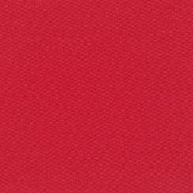Close-up of warm tomato-red fabric with a subtle fine plain-weave texture