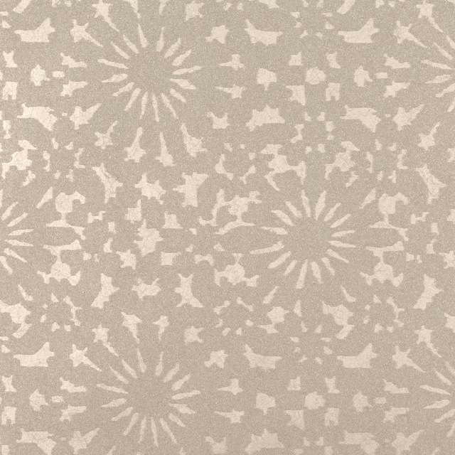 Greige taupe wallpaper with ivory sunburst medallions and scattered organic flecks