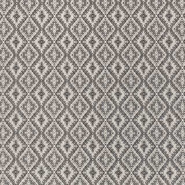 Cool slate-grey textile with ivory diamond motifs in a dense woven texture
