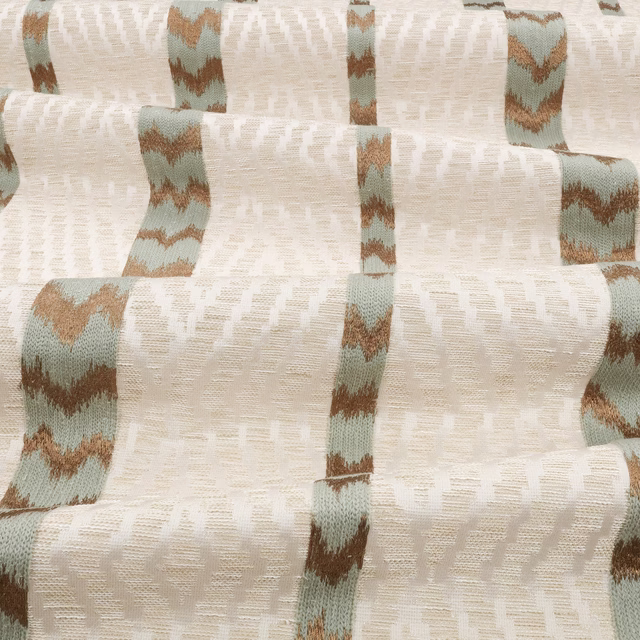 Warm cream woven ground with muted sage-blue and brown broken vertical bands