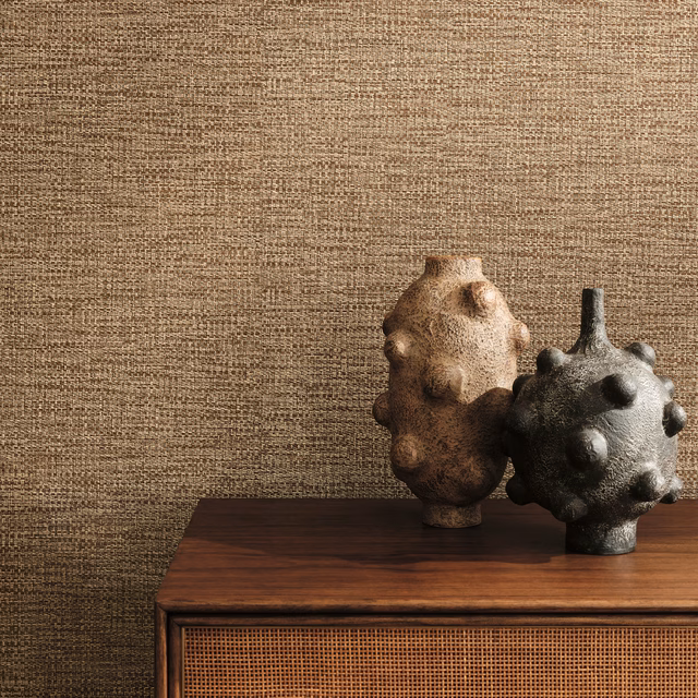 Warm cinnamon-brown woven-look wallpaper with fine horizontal texture beside dark ceramic vessels