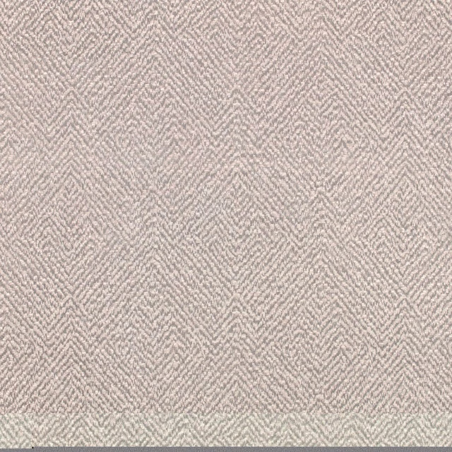 Pale mist-grey wallpaper with a fine repeated chevron motif and softly textured surface