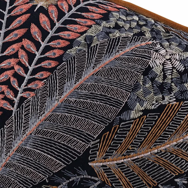 Near-black botanical fabric with coral, ivory and ochre embroidered leaves