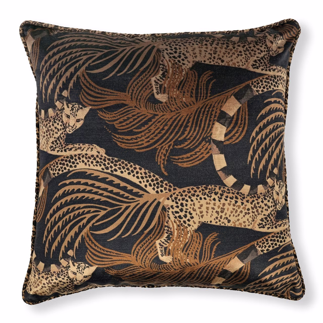 Ancient gold leopard and palm motifs on a deep charcoal velvet cushion