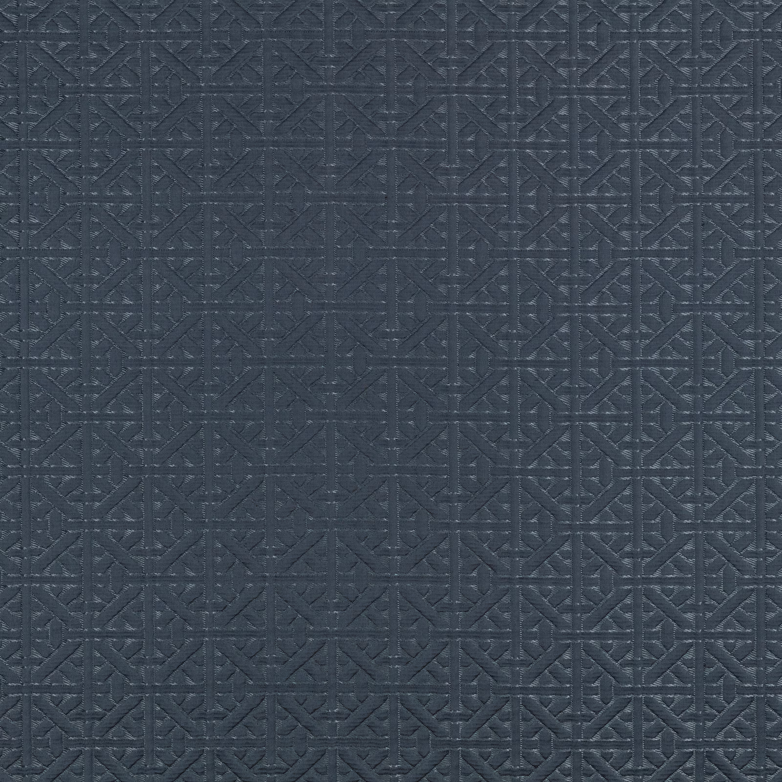 Midnight blue textile with a raised interlocking geometric lattice and charcoal-toned texture
