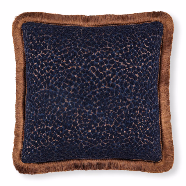 Deep indigo mottled textile with raised texture and warm brown fringed edge