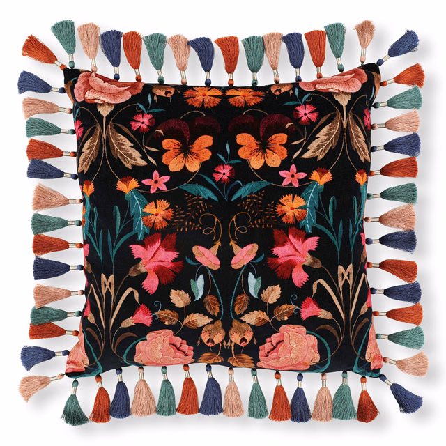Black floral textile with coral roses, teal foliage and multicoloured tassel edging