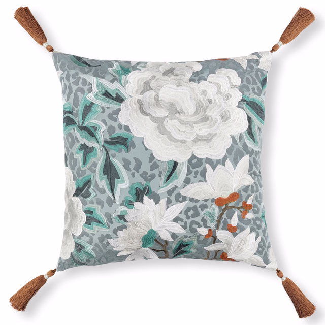 Blue-grey floral embroidered cushion with teal leaves, white blooms and brown tassels
