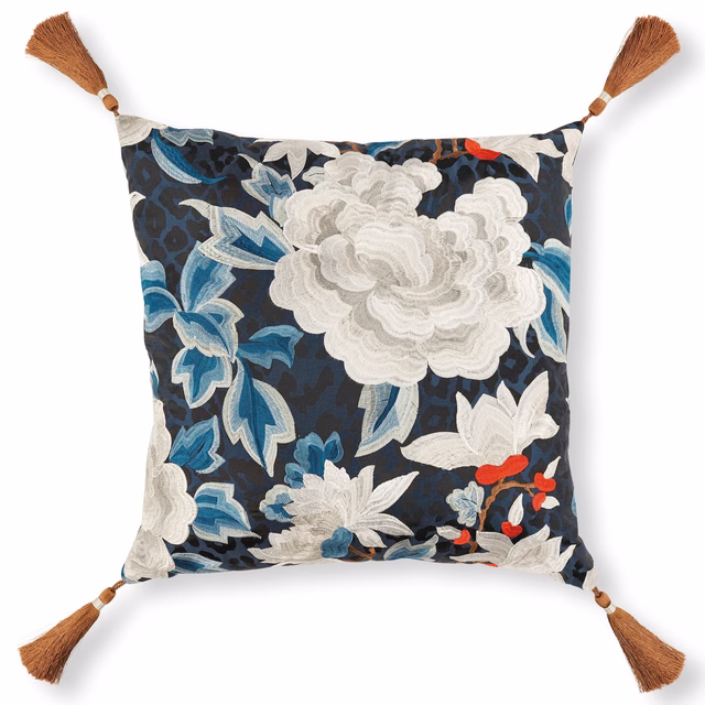 Deep navy cushion with oversized ivory blooms, blue leaves, red accents and brown tassels