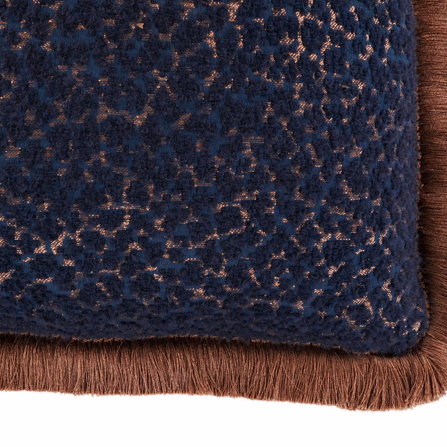 Dark indigo textured cushion with copper flecks and brown fringe