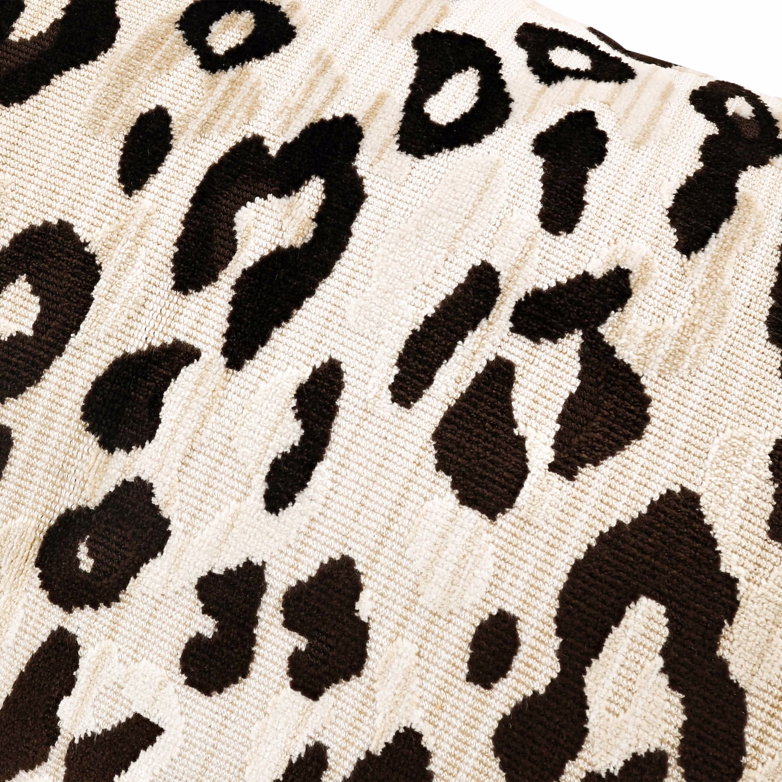 Warm cream velvet with espresso-black abstract animal spots and visible raised texture