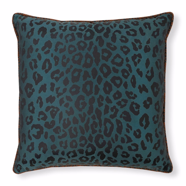 Deep peacock teal cushion with irregular black animal spots and dark piped edge