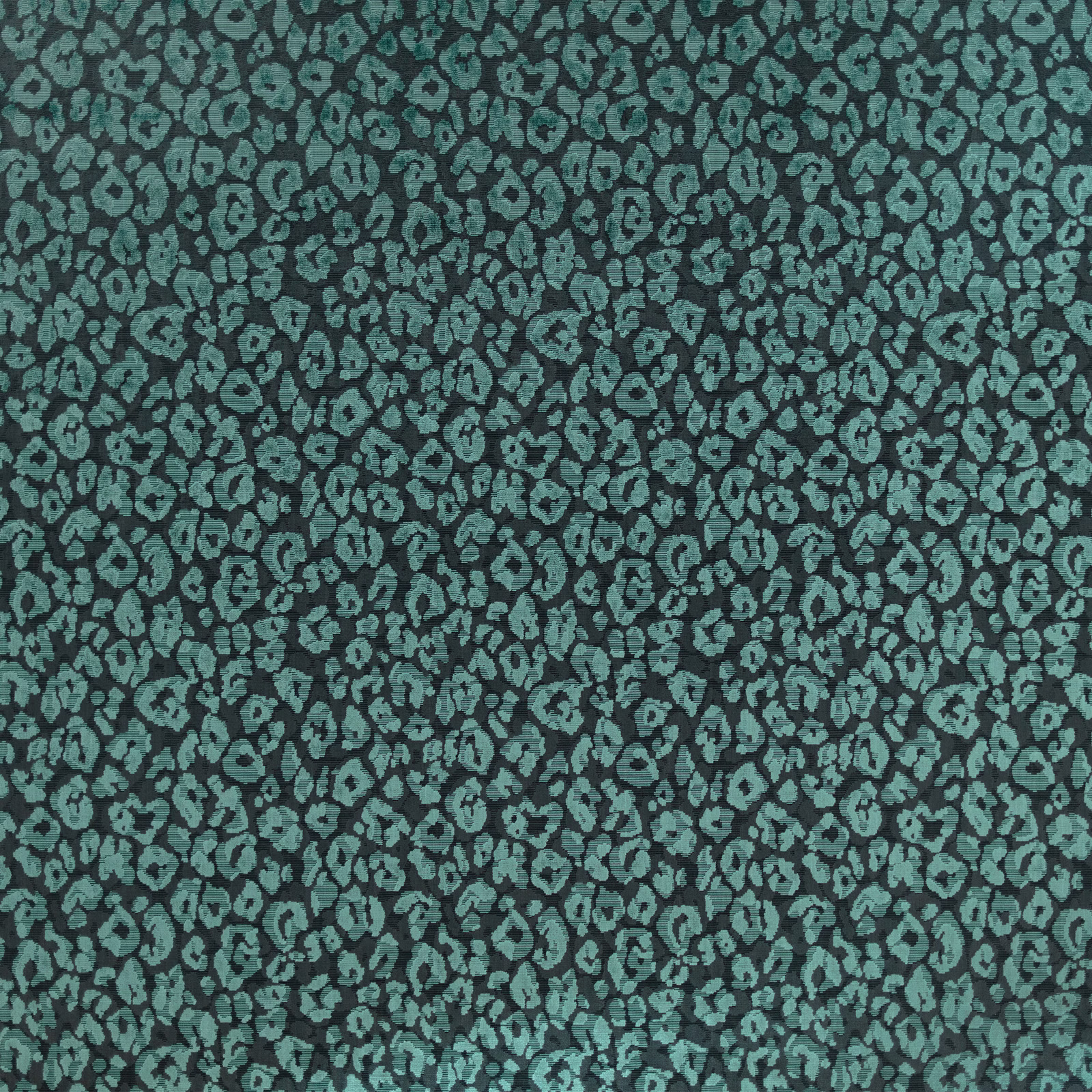 Close-up of jade teal woven textile with dense charcoal animal-like pebble motifs