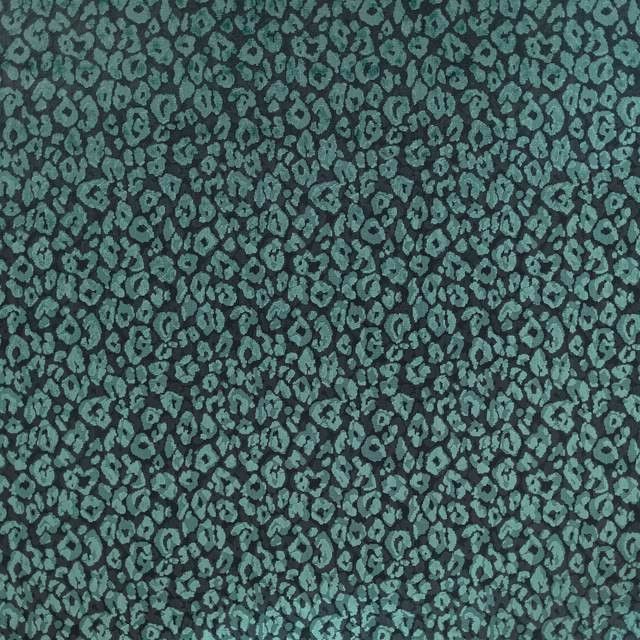 Close-up of jade teal woven textile with dense charcoal animal-like pebble motifs
