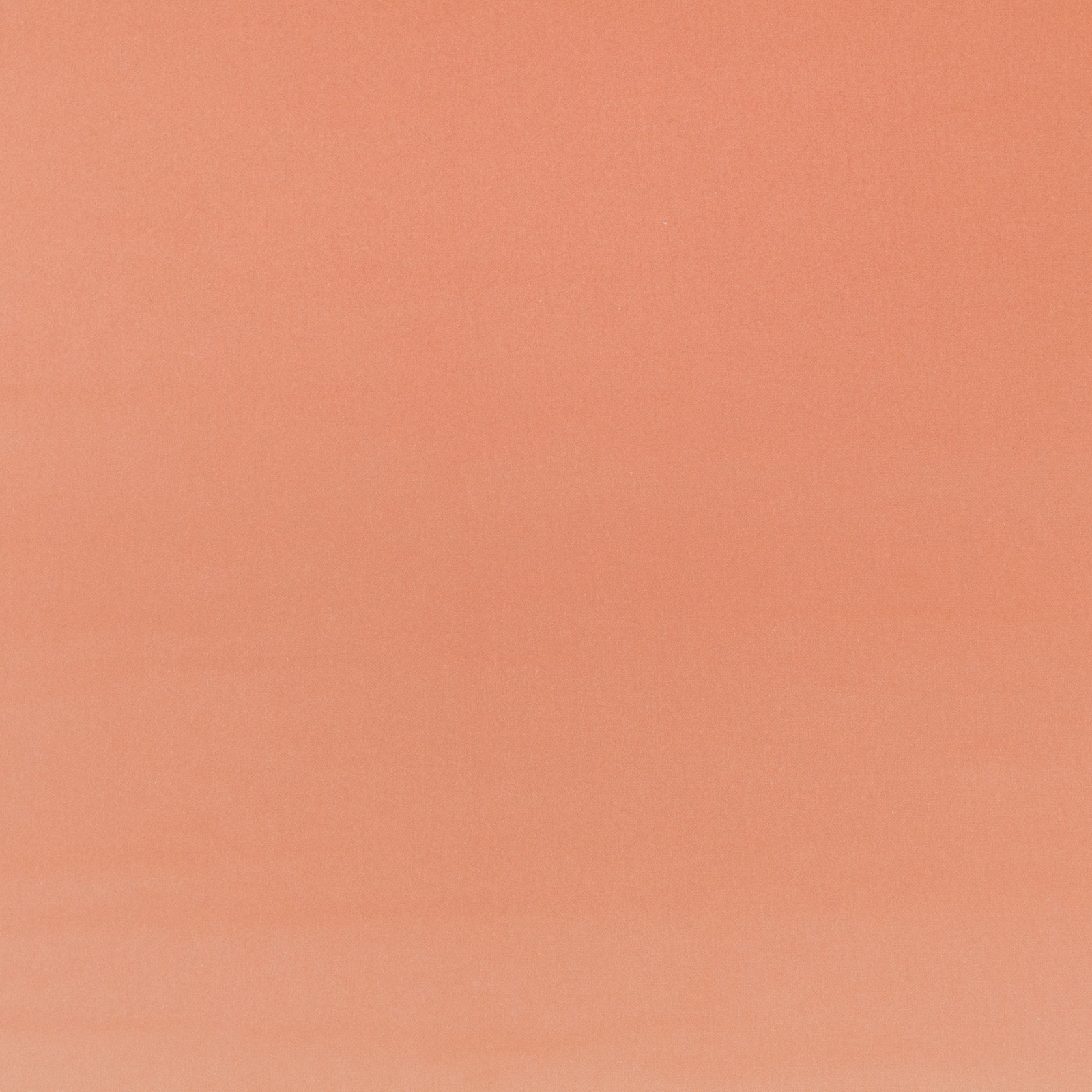 Close-up of plain coral-peach velvet with a softly brushed, subtly directional surface