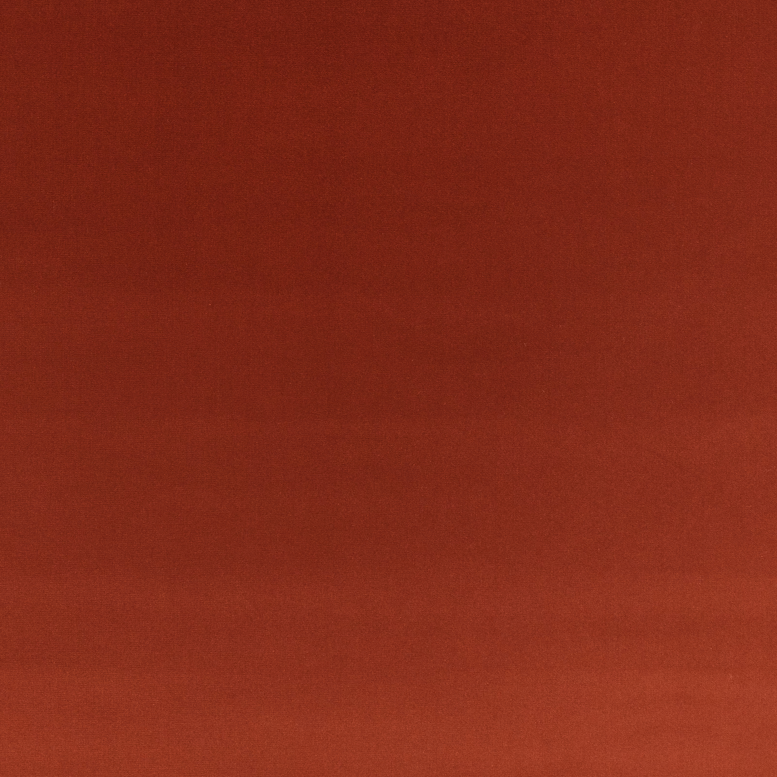 Warm russet red velvet with subtle directional nap shading across its plain surface
