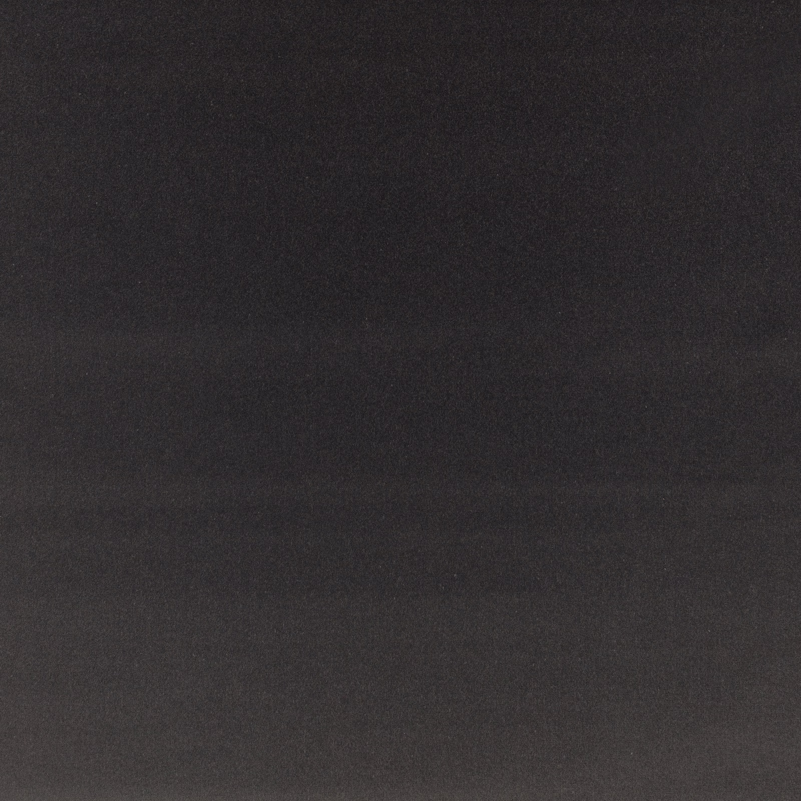 Close-up of plain charcoal slate velvet with a soft, subtly directional nap