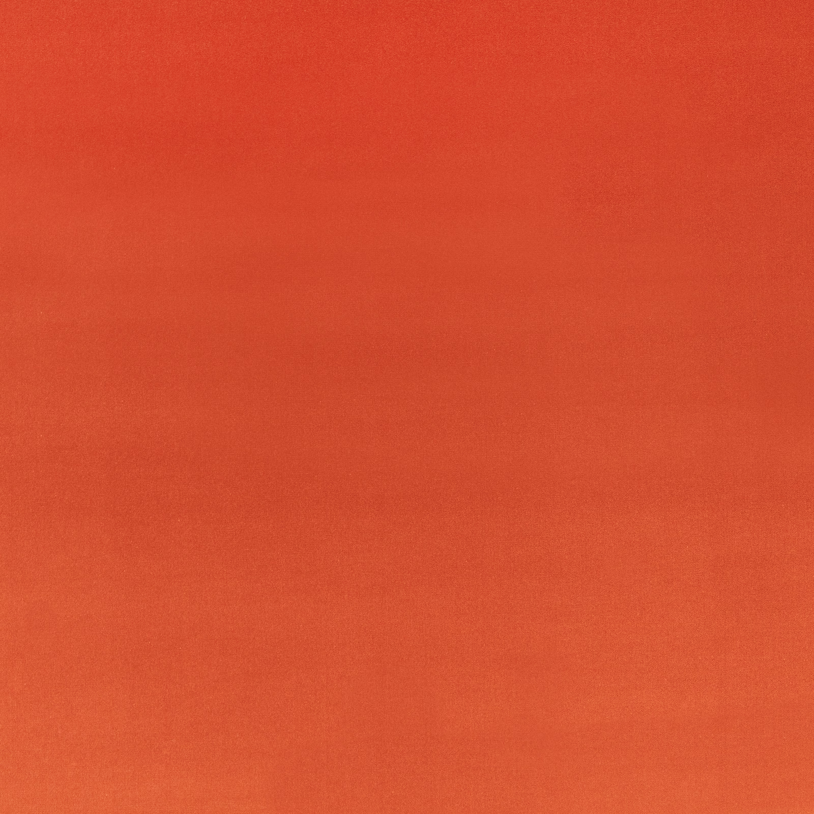Close-up of warm sumac terracotta velvet with a soft, subtly shifting nap