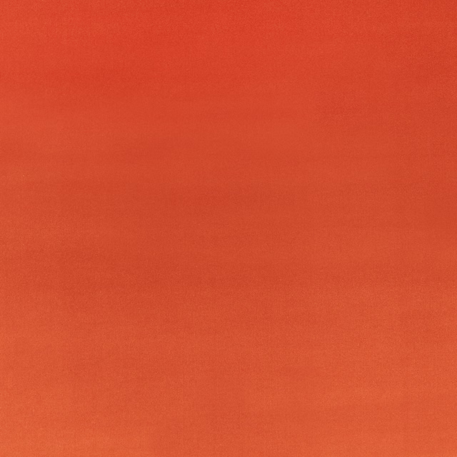 Close-up of warm sumac terracotta velvet with a soft, subtly shifting nap