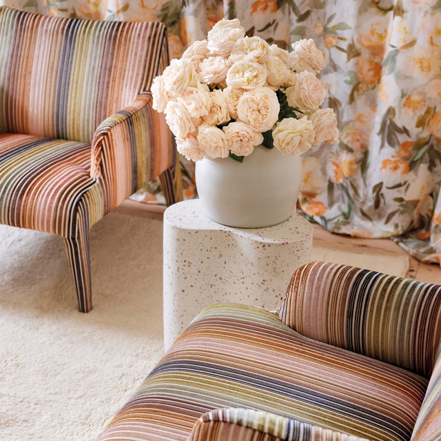 Copper, cream, olive and charcoal ribbed stripes across upholstered armchairs and sofa