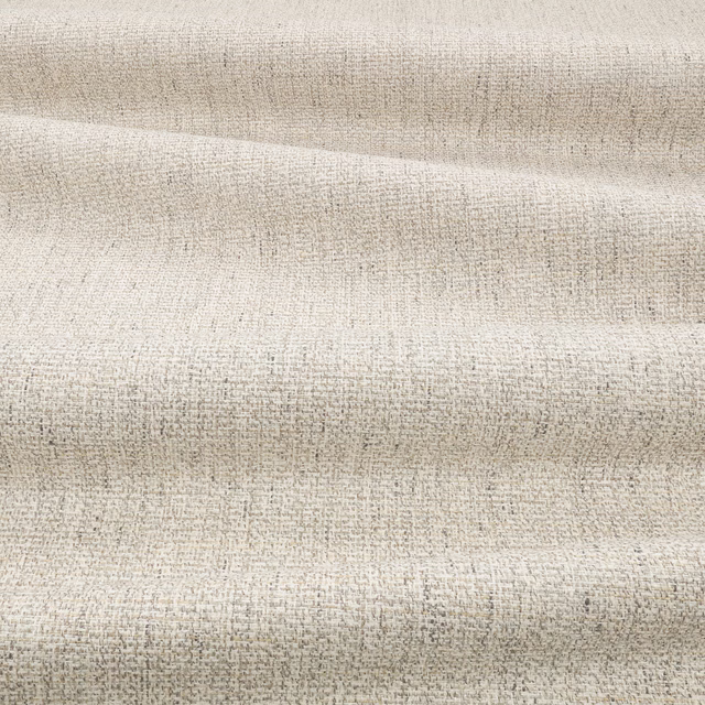 Pale beige woven textile with fine taupe flecks and softly ridged folds