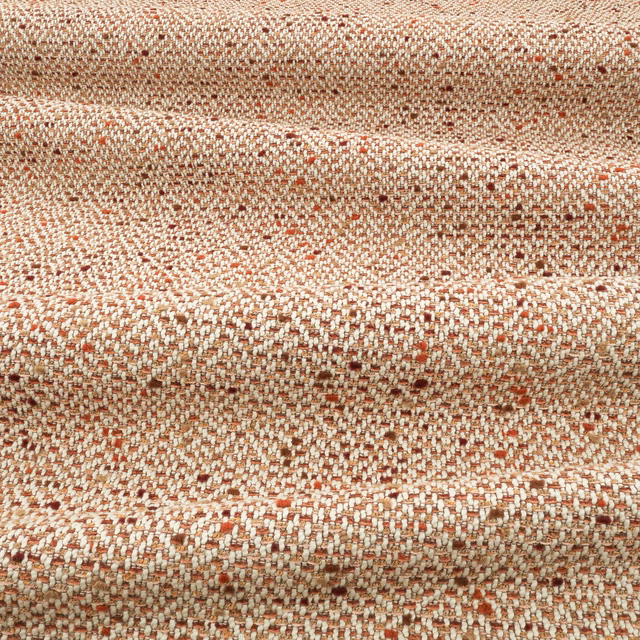 Close-up of russet, cream and terracotta flecked chunky woven upholstery fabric
