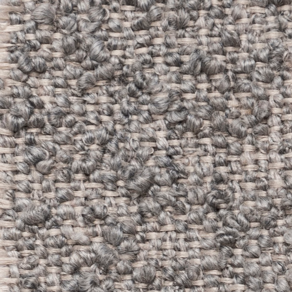 Close-up of a mottled pebble-grey textured weave with knotted slubs