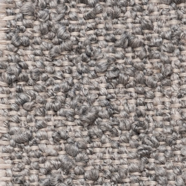 Close-up of a mottled pebble-grey textured weave with knotted slubs
