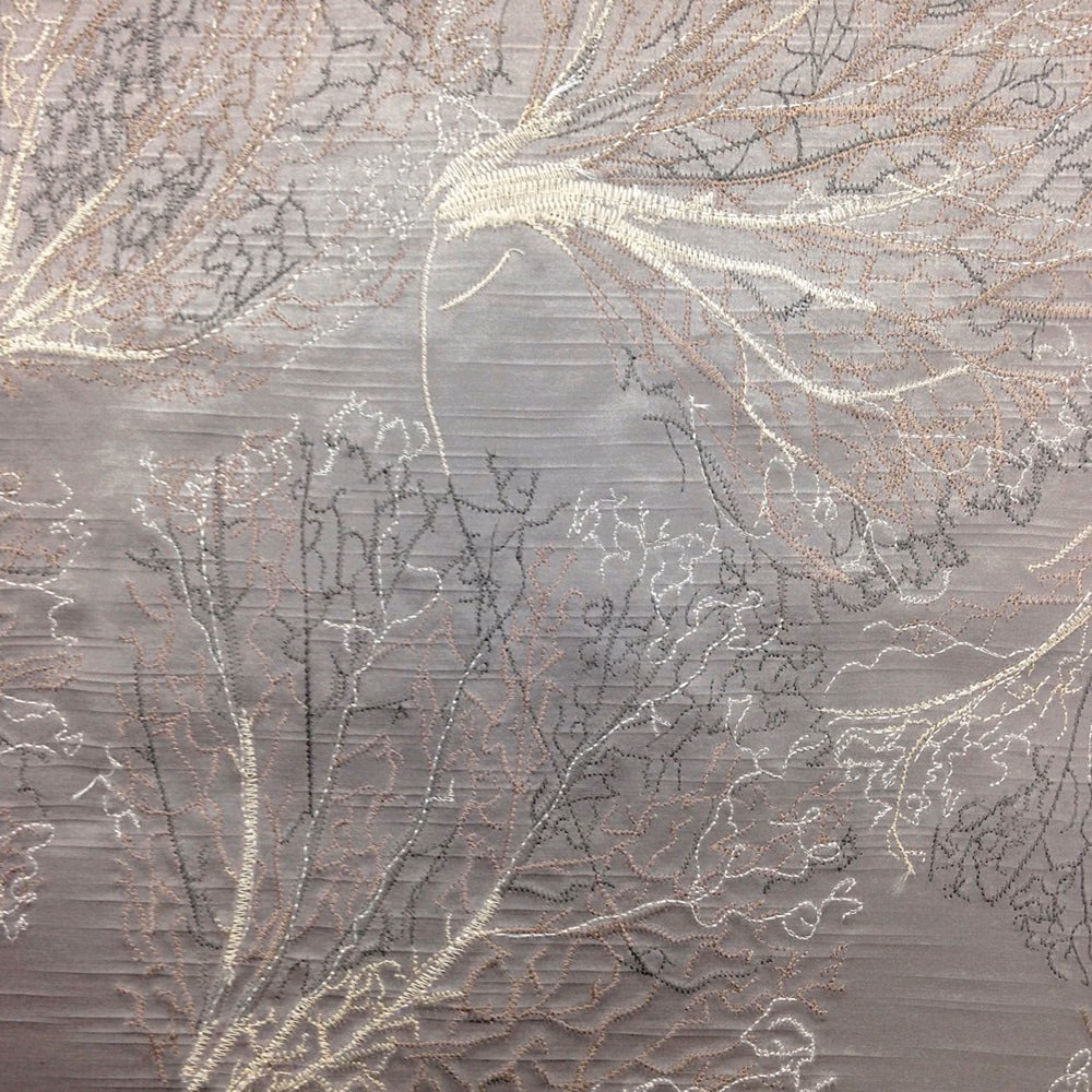 Grey botanical fabric swatch with shimmering leaf outlines and textured weave
