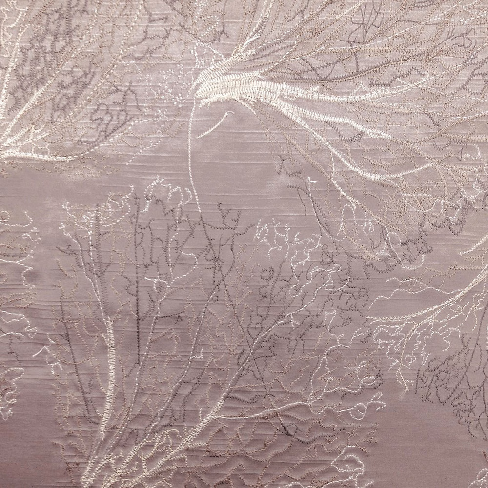 Dusty pink botanical fabric with shimmering ivory leaf outlines and fine woven texture