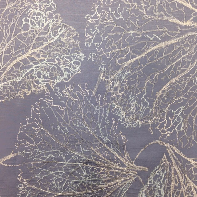 Smoky purple fabric swatch with pale embroidered botanical leaves