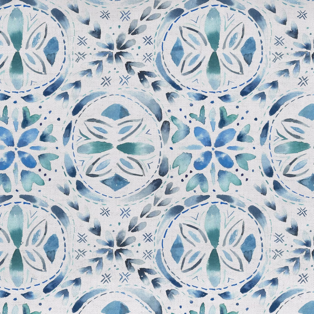 Blue and teal folk floral medallion fabric on a pale ground