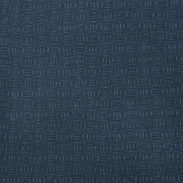 Muted slate blue woven fabric with a small geometric grid texture