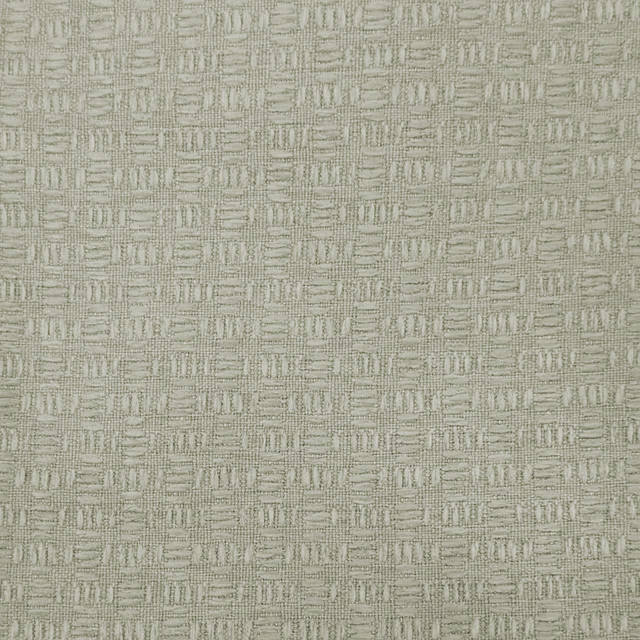 Close-up of a soft warm cream woven fabric with a small geometric texture