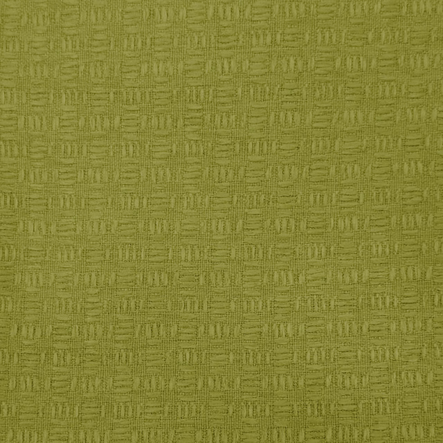 Close-up of a yellow-green textured woven fabric with small geometric pattern