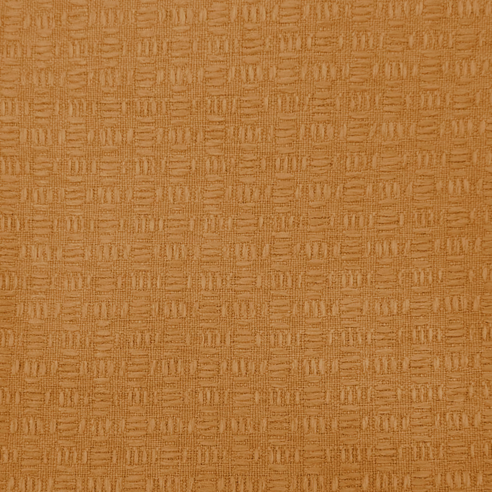 Close-up of warm orange textured fabric with a small woven geometric pattern